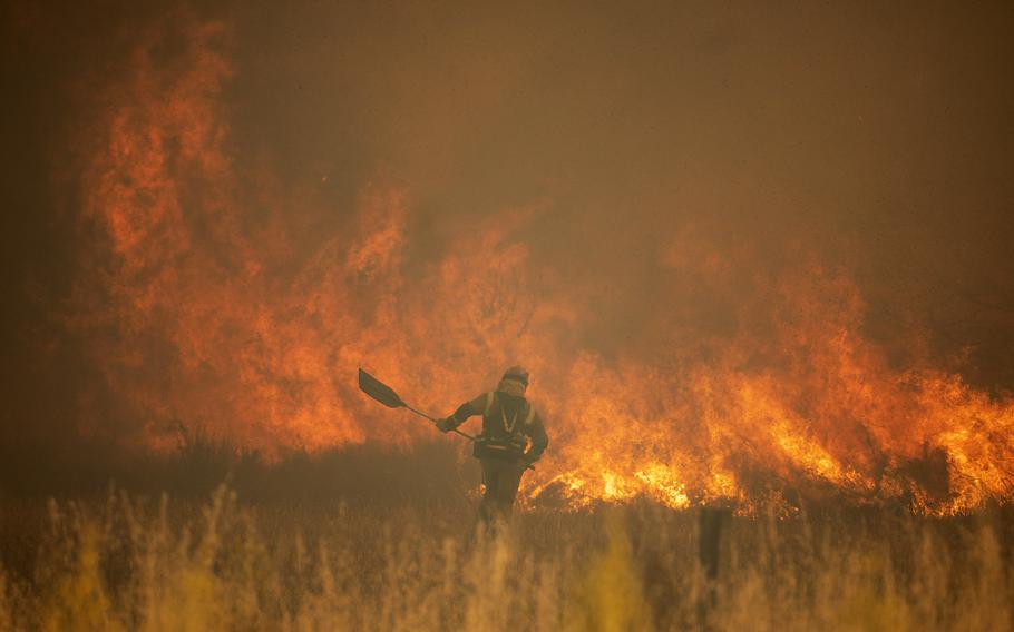 A firefighter works in front of flames during a wildfire in the Sierra de la Culebra in the Zamora Province, Spain, on Saturday, June 18, 2022. Thousands of hectares of wooded hill land in northwestern Spain have been burnt by a wildfire that forced the evacuation of hundreds of people from nearby villages. Officials said the blaze in the Sierra de Culebra mountain range started Wednesday during a dry electric storm.