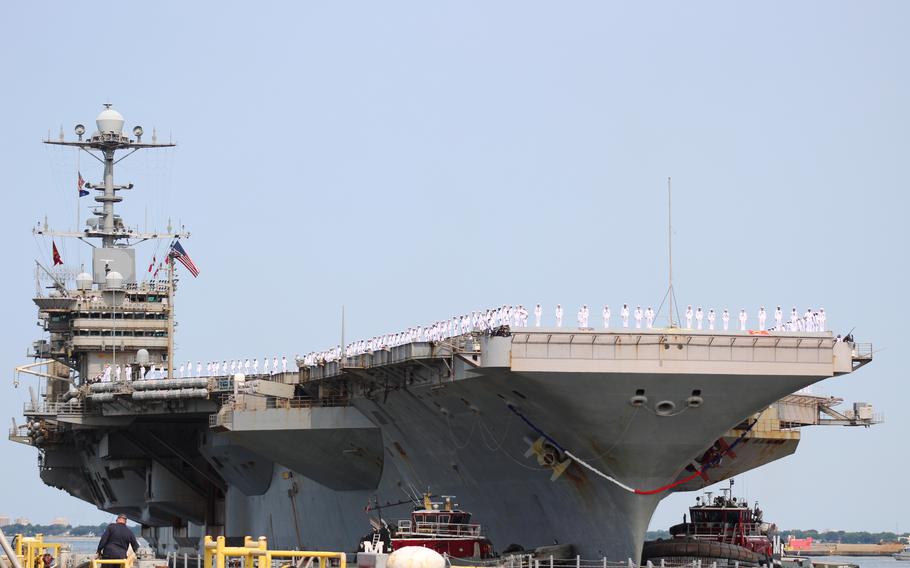 Sailors donning their dress whites manned the rails of the USS Harry S. Truman 
