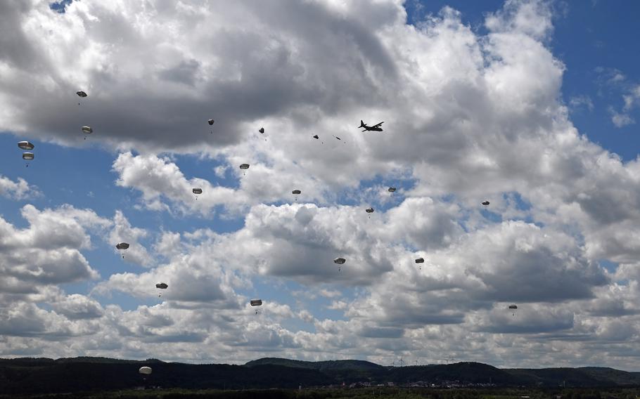 Nine C-130J Super Hercules fly in formation after taking off from Ramstein Air Base, Germany, on May 25, 2022. The planes dropped 90 paratroopers in quick succession onto a grassy landing zone between the base’s two runways.