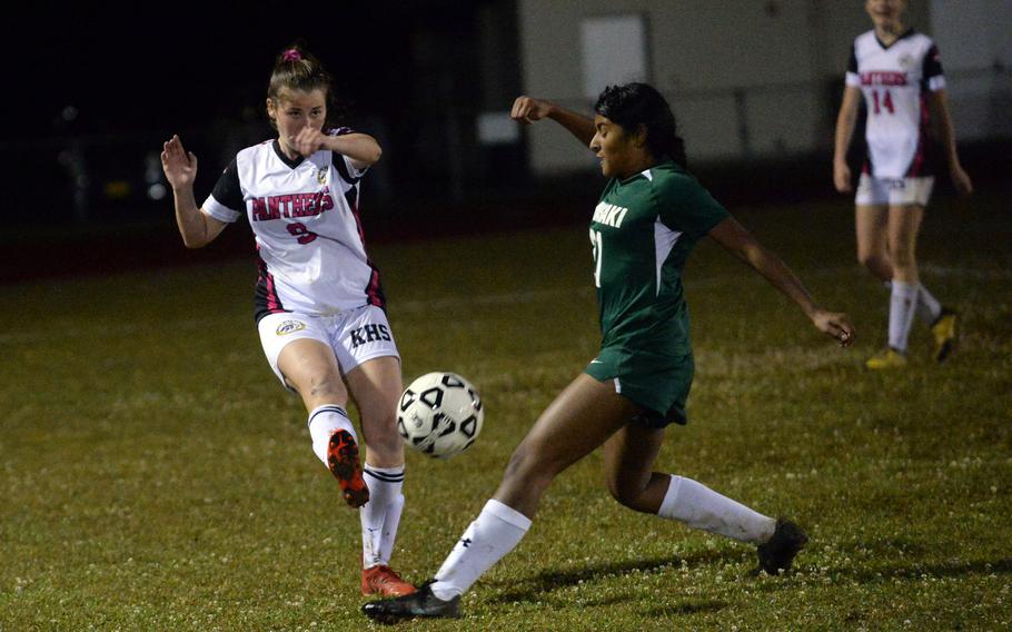 Kadena's Mary Tracy boots the ball past Kubasaki's Solares Solano during Wednesday's Okinawa girls soccer match. The Dragons won 6-2.