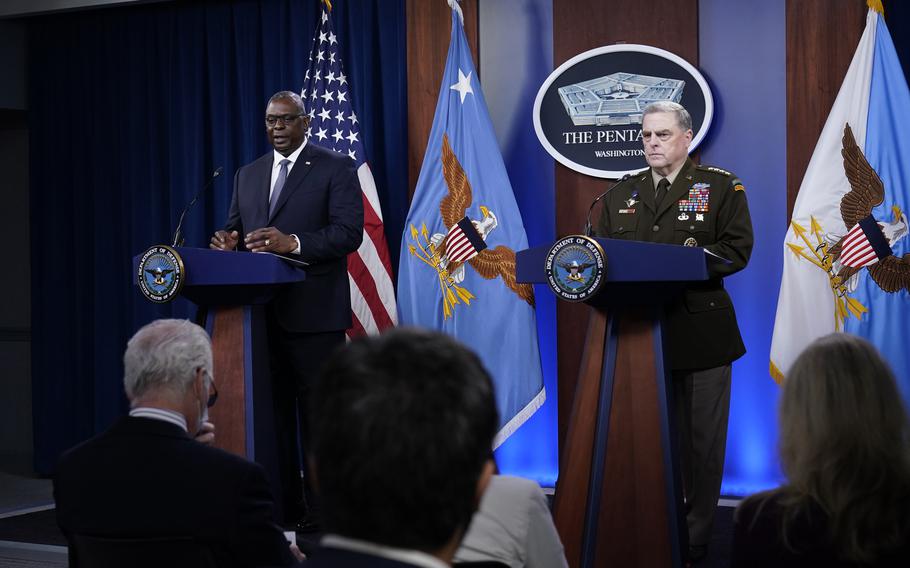 Secretary of Defense Lloyd Austin, left, answers a question during a briefing with Chairman of the Joint Chiefs of Staff Gen. Mark Milley, right, at the Pentagon in Washington, Wednesday, Sept. 1, 2021, about the end of the war in Afghanistan.