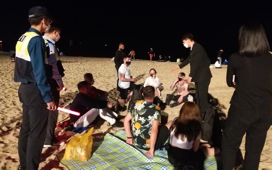 South Korean police responded to more than 30 reports of a large party involving 1,500 or more foreigners at Haeundae Beach in Busan, Saturday, May 29, 2021. Many were disregarding South Korea’s coronavirus rules for wearing masks in public areas, maintaining 6 feet between individuals and limiting groups to five people. 