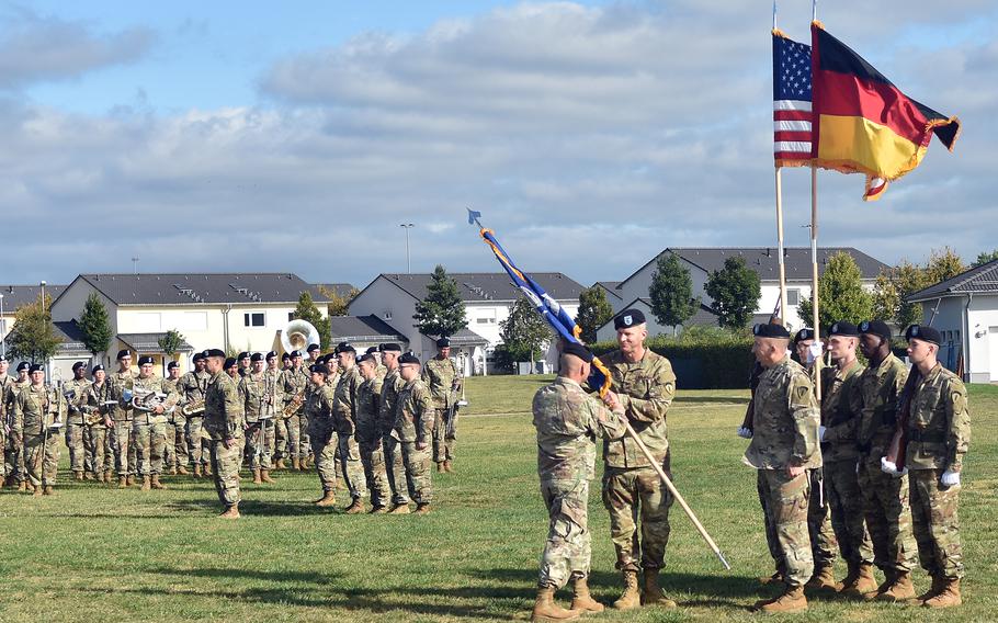 Gen. Christopher Cavoli, left, the U.S. Army Europe and Africa commander, passes the 2nd Multi-domain Task Force colors to Col. Jonathon Byrom at an activation ceremony for the unit Sept. 16, 2021, in Wiesbaden, Germany.