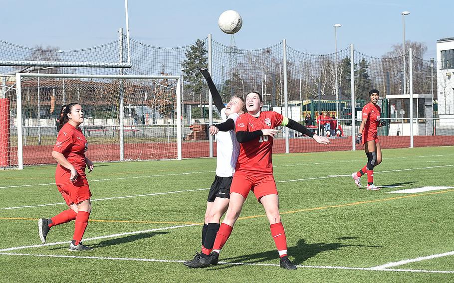 Stuttgart midfielder Regan Stewart, center left, and Kaiserslautern midfielder Georgia Rawcliffe, center right, tossle for the ball during a girls soccer match on March 9, 2024, at Kaiserslautern High School in Kaiserslautern, Germany.