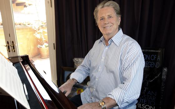 Wilson at the piano for a posed photo.
