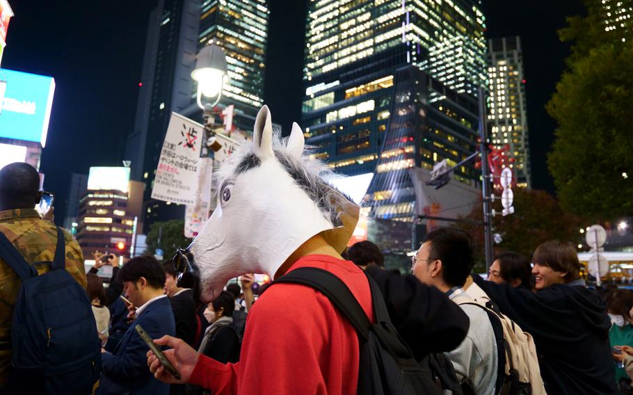A Halloween reveler waits to cross the scramble intersection in Tokyo's Shibuya ward, Tuesday, Oct. 31, 2023.