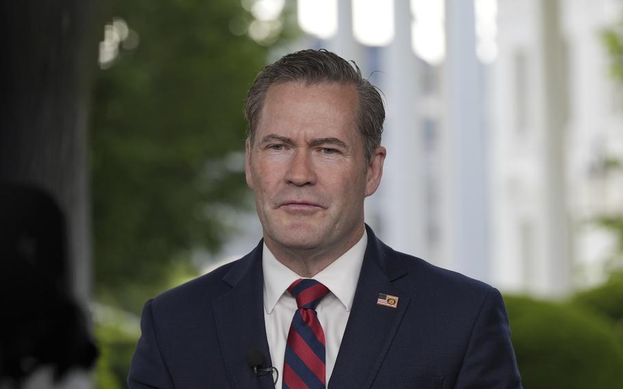 Mike Waltz in a suit and tie with a microphone near his chest.