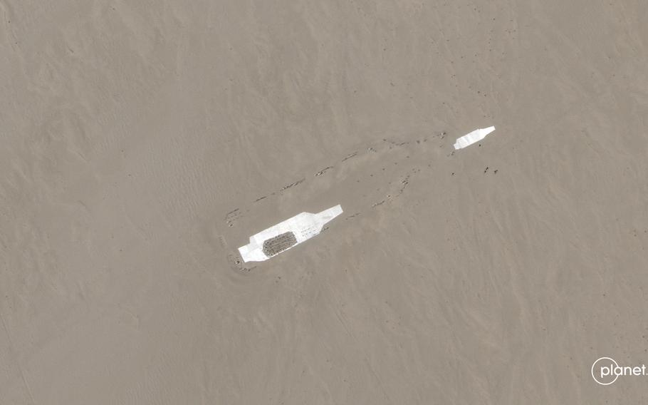 Planet Labs captured photos of China's new mock targets on Jan. 1, 2023. Two carrier-shaped targets lie within a larger carrier outline in the desert.