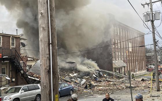 Emergency personnel work at the site of a deadly explosion at a chocolate factory in West Reading, Pa., Friday, March 24, 2023.  ( Ben Hasty /Reading Eagle via AP)