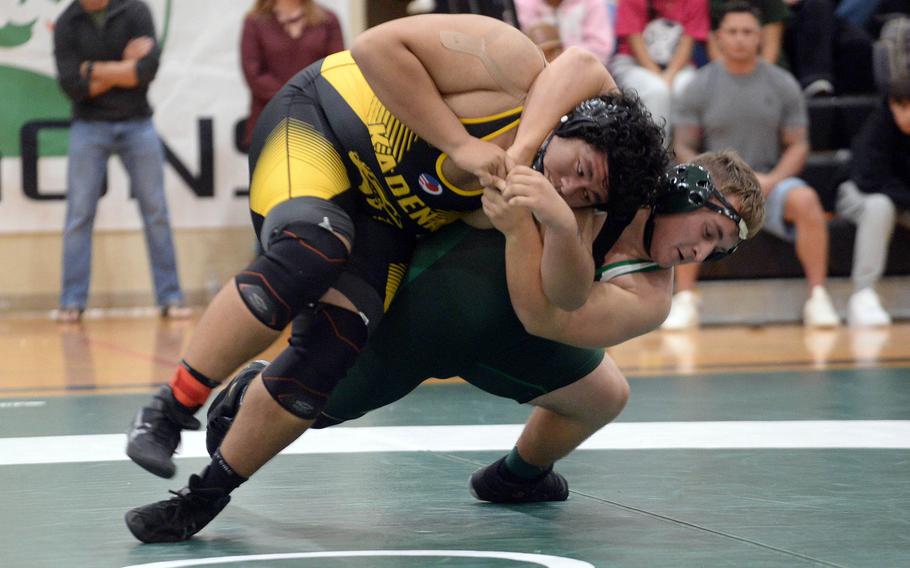 Kubasaki heavyweight Anthony Finegan shoulder throws Kadena's Nathaniel Macias during Wednesday's Okinawa wrestlibg dual meet. Finegan pinned Macias in 2 minutes, 1 seconds, but the Panthers won the meet 35-26 to go 2-0 on the season.