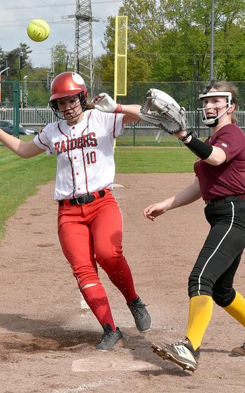 Kaiserslautern's Mariska Campbell, left, beats the throw to Vilseck's Lily Bravo at home plate on Saturday morning at Kaiserslautern High School in Kaiserslautern, Germany. The Raiders swept the Falcons 7-3 and 24-12.