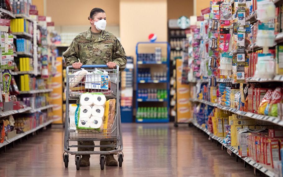 An airman shops at the commissary at RAF Mildenhall, England. U.S. Air Force personnel are required to wear face masks while visiting many public base facilities. On July 19, the U.K. is expected to end mask mandates in England, but the Air Force may choose to retain stricter rules.