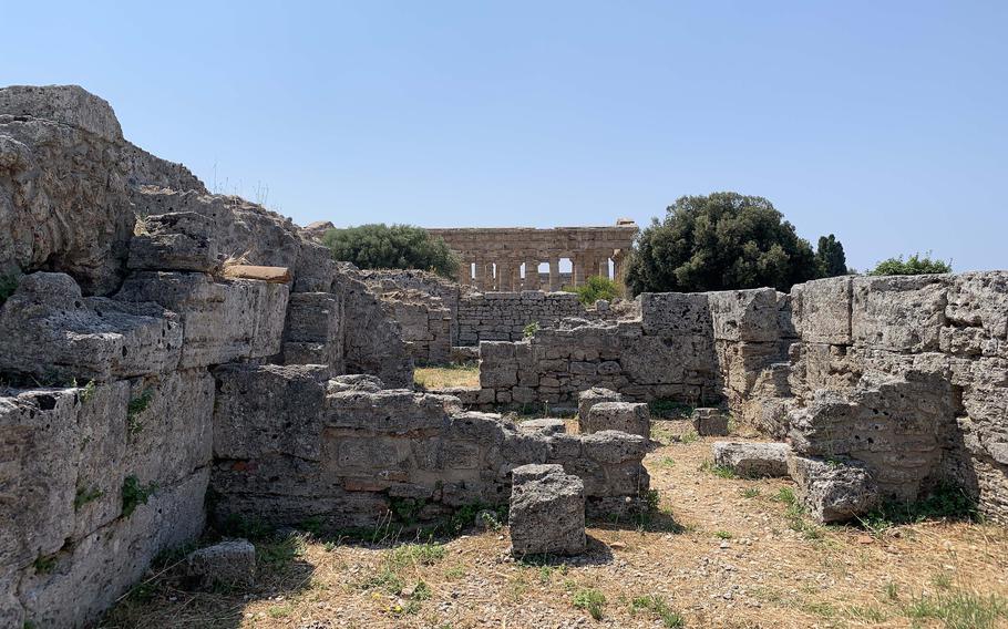 The Temple of Neptune is visible from the ruins of Paestum. The ruins include a Roman amphitheater, market area and well-preserved walls that surround the city. 