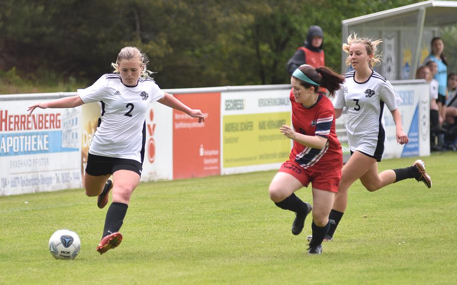 Stuttgart's Eva Eaton prepares to cross the ball into the box during the Panther's pool-play matchup with Lakenheath on May 15, 2023, in Reichenbach-Steegen, Germany. Defending is the Lancers' Alyssa Salinas, while Stuttgart's Issa Sanchez is at right.