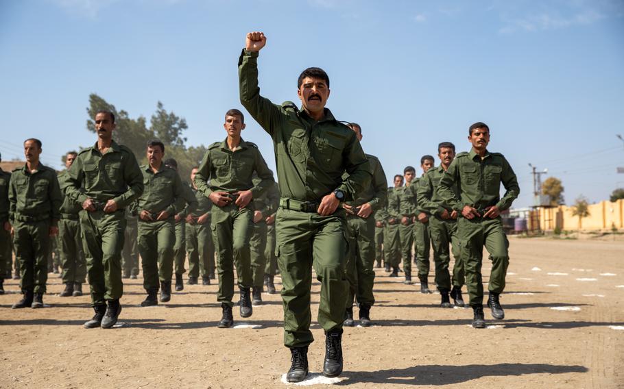 Syrian training academy members march during a graduation ceremony in the al-Shaddadi region of Syria on April 3, 2023. U.S. partner forces in Syria have been susceptible to bribes and are distracted from the mission against the Islamic State by attacks from Turkey, an inspector general report assessed in August.