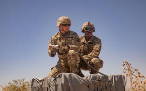 From left, U.S. Army Sgt. Davis Duncan, with 759th Military Police Battalion, 89th Military Police Brigade, assigned to Joint Task Force-Southern Border, and Sgt. Tyrese Stanley, with Alpha Company, 189th Division Sustainment Support Battalion, 82nd Airborne Division, assigned to Joint Task Force-Southern Border, prepare to hook up a sling load to a CH-47 Chinook, at Fort Bliss, Texas, July 16, 2025. Sling load capabilities allow for equipment up to 25,000lbs to be transported by helicopter to remote areas of the border. JTF-SB executes full scale, agile, and all-domain operations in support of U.S. Customs and Border Protection to protect the territorial integrity of the United States and achieve 100% operational control of the southern border. (U.S. Army photo by Staff Sgt. Rynishia Lewis)