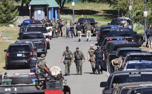 Law enforcement and emergency responders at Cherry Hill Park off 15th Street on Sunday afternoon, June 29, 2025, following reports of an ambush shooting attack on Canfield Mountain, in Coeur d'Alene, Idaho. (Bill Buley/Coeur D'Alene Press via AP)