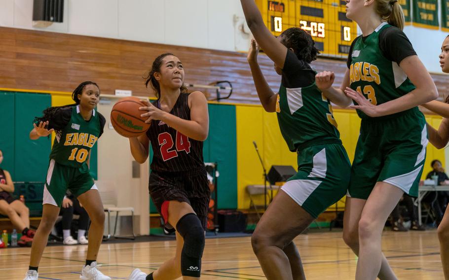 Nile C. Kinnick's Kotone Turner drives to the basket against Robert D. Edgren's defense during Saturday's DODEA-Japan girls basketball game. The Red Devils won 42-9 to complete the two-game weekend sweep.