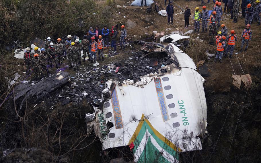 Rescuers scour the crash site in the wreckage of a passenger plane in Pokhara, Nepal, Monday, Jan.16, 2023. The Yeti Airlines flight from Kathmandu that plummeted into a gorge Sunday killed at least 70 passengers out of the 72 on board.