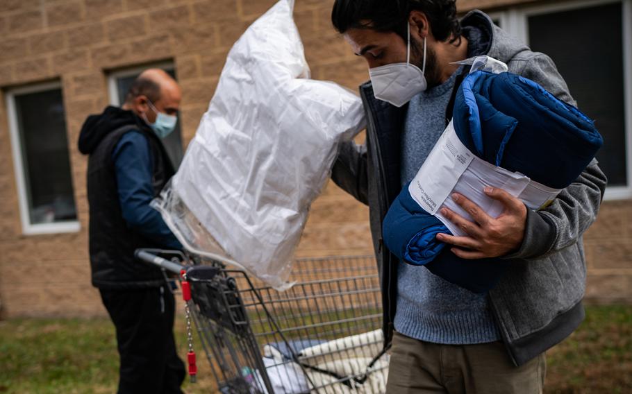 Mohammad Edrees, 29, right, loads his car with donations from Lutheran Social Services in Fairfax County, Va., on Dec. 6. 