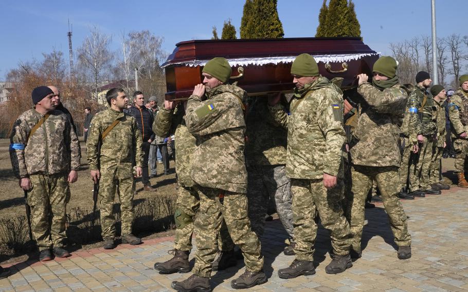 Ukrainian soldiers carry a coffin as they pay their last tribute to colonel Valeriy Gudz who was killed in a battle against Russians, at a cemetery in the town of Boryspil close to capital Kyiv, Ukraine, Tuesday, March 15, 2022. Russian forces are pounding Ukrainian cities and edging closer to the capital, Kyiv, in a relentless bombardment that keeps deepening the war’s humanitarian crisis. 