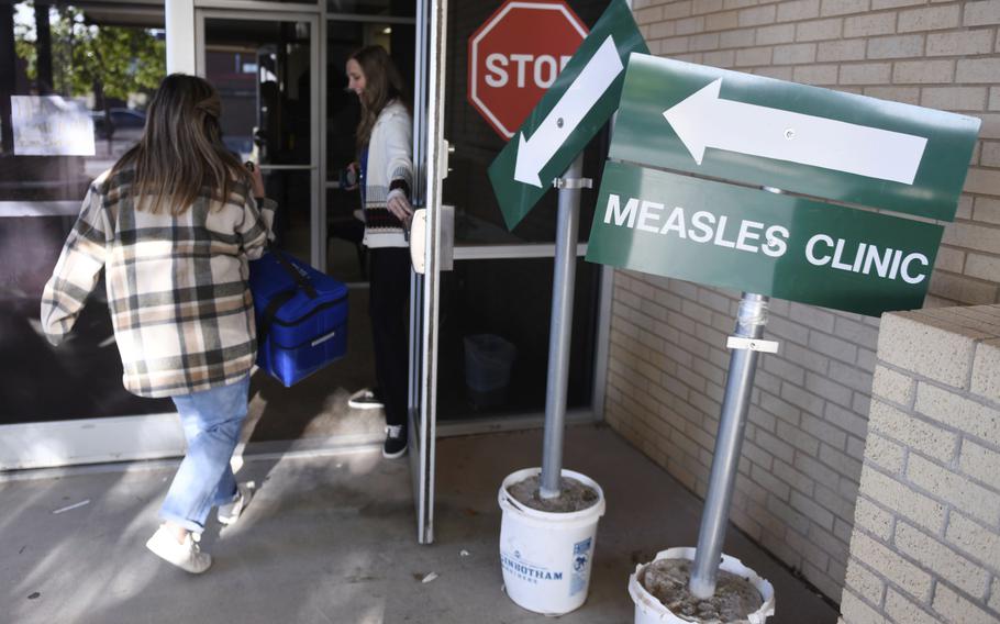 Health department staff members enter the Andrews County Health Department measles clinic 