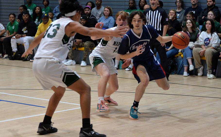 Aviano’s Gabriele Fabbro looks for an outlet as he is defended by Naples’ Scott Johnson, left, and Camden Kasparek, in a Division II semifinal at the DODEA-Europe basketball championships in Ramstein, Germany, Feb. 17, 2023. 