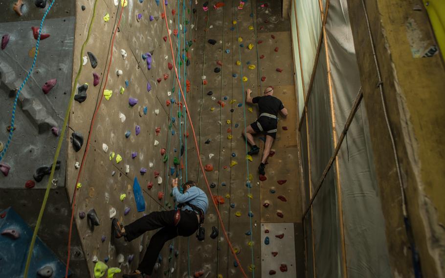 Kozachok, on right, has found solace in rock climbing at a gym in Kyiv after losing his vision.