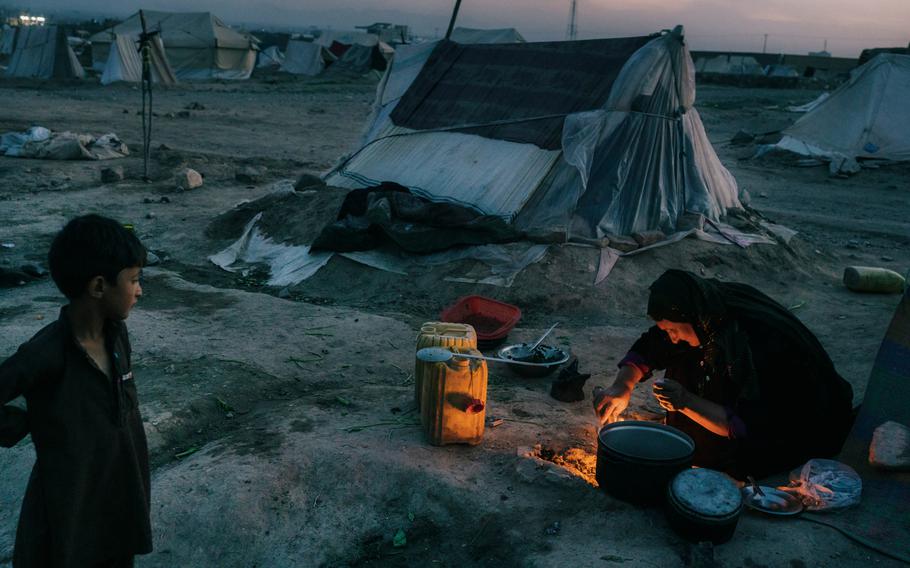 A woman prepares dinner on a campfire in the Shedai displaced persons camp outside the city of Herat, Afghanistan, in March. 