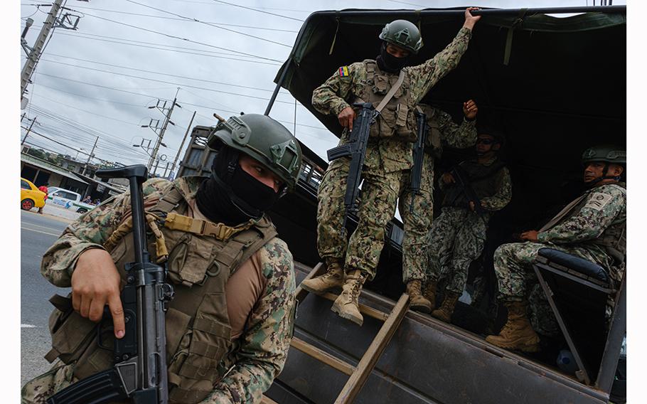 Soldiers on Tuesday guard a prison in Guayas province. Many of the presidential candidates have promised to control Ecuador’s gang-run prisons. 
