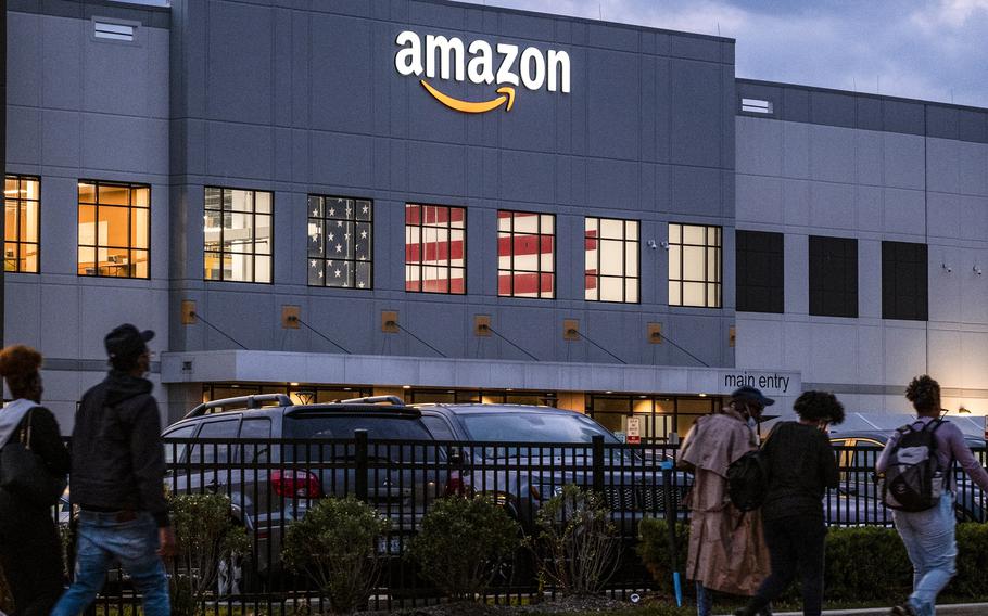 People arrive for work at the Amazon distribution center in the Staten Island borough of New York, on Oct. 25, 2021.