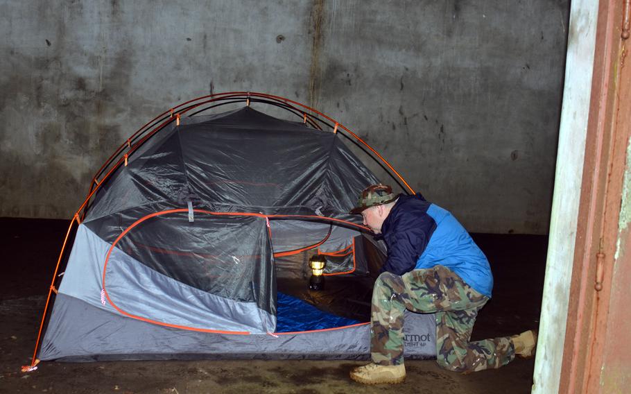 Tama Hills' group reservation coordinator, Joe Zurenko, shows off a World War II-era bunker where visitors can camp at the U.S. military recreation area in Tokyo, Saturday, July 1, 2023.