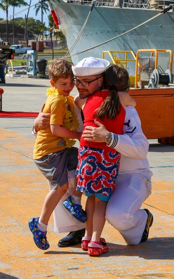 A sailor assigned to the Ticonderoga-class guided missile-cruiser USS Antietam (CG 54) reunites with family after arriving at new homeport Joint Base Pearl Harbor-Hickam, Hawaii, Friday, April 5, 2024. 