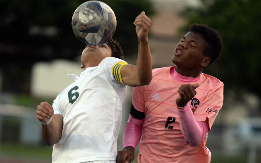 Kubasaki’s Justin Murray heads the ball against Kadena’s Derek Vaden during Wednesday’s DODEA-Okinawa boys soccer match. The teams played to a scoreless draw.