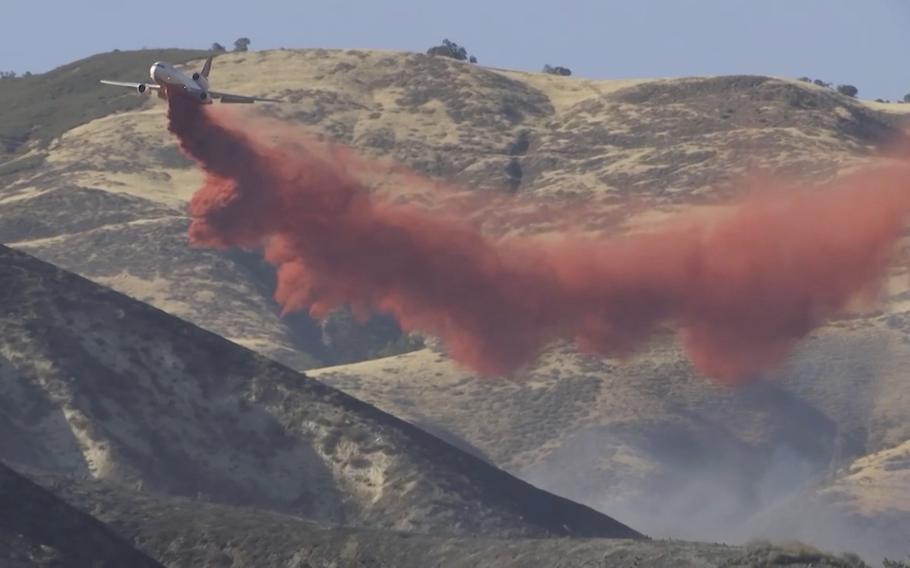 Red fire suppressor is released from the plane.