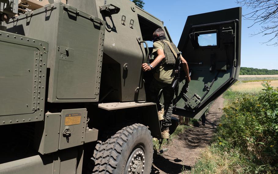 Kuzia, the commander of the unit, gets inside the HIMARS vehicle in Eastern Ukraine on July 1, 2022. 