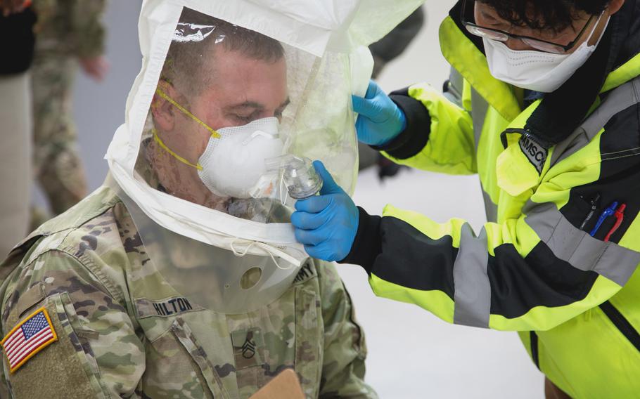 A soldier of the 19th Expeditionary Sustainment Command tests a respirator to ensure a proper fit during COVID-19 prevention training at Camp Carroll, South Korea, on March 24, 2020. 