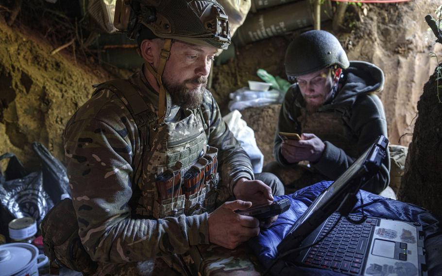 Ukrainian servicemember Andrii of the Air Assault Forces 148th separate artillery brigade sends receiving coordinates for a drone at the front line in Donetsk region, Ukraine, Thursday May 9, 2024. 