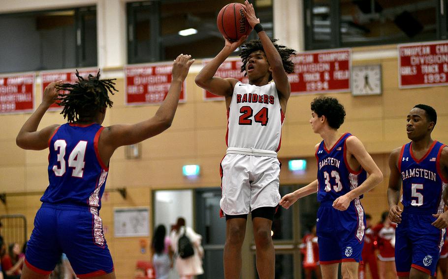 Kaiserslautern's Reuben Todman shoots over Ramstein's Tyrell Edwards during a Jan. 31, 2024, game at Kaiserslautern High School in Kaiserslautern, Germany.