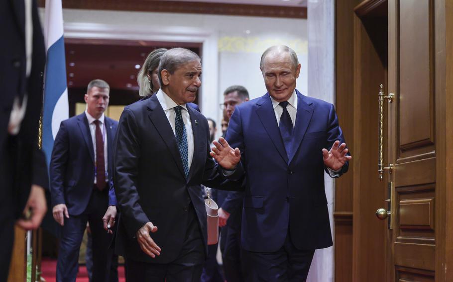 Two men talk while walking.