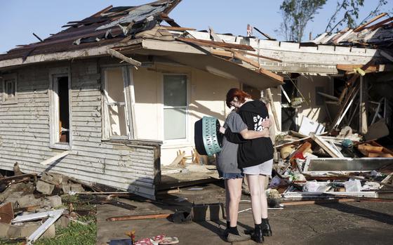 Joy King, left, and her granddaughter Crystal Maxey hug in front of King's house that was destroyed by a tornado Tuesday, May 7, 2024 in Barnsdall, Okla. The two were looking for King's cats and salvaging what items they could. (Mike Simons/Tulsa World via AP)