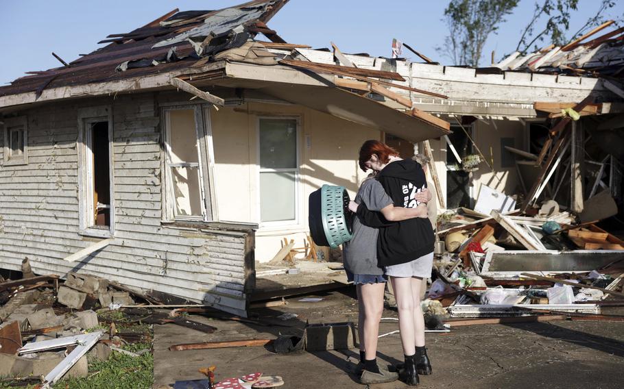 Joy King, left, and her granddaughter Crystal Maxey hug in front of King’s house, which was destroyed by a tornado, Tuesday, May 7, 2024, in Barnsdall, Okla. The two were looking for King’s cats and salvaging what items they could.