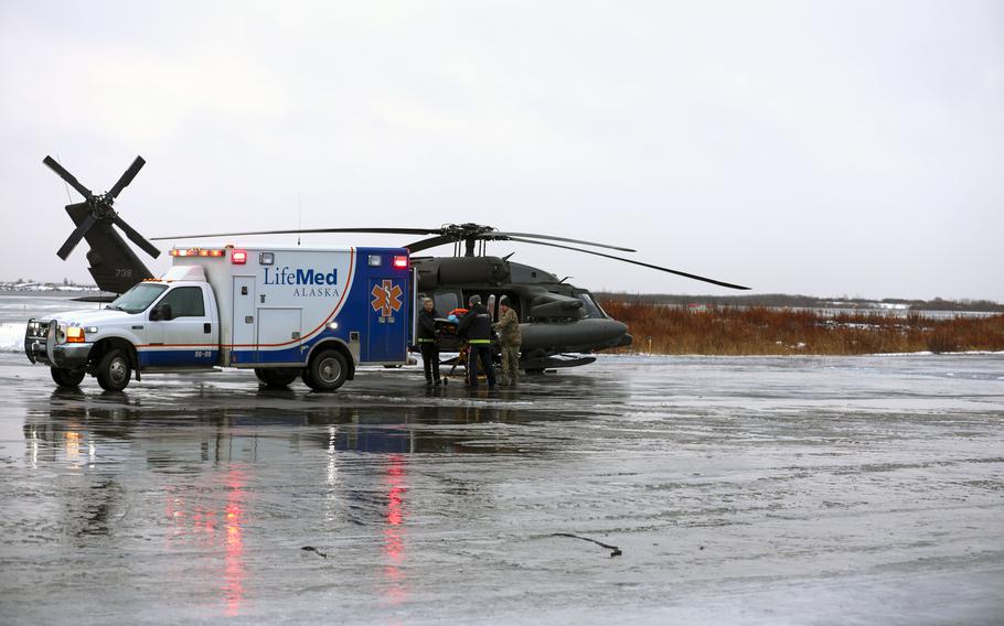 This photo provided by the Alaska National Guard shows,from the left, Holly Demmert and Clifton Dalton, both flight paramedics with LifeMed, and Chief Warrant Officer 3 Bryan Kruse, Bethel Army Aviation Operating Facility commander, move a critically ill patient from an AKARNG UH-60L Black Hawk helicopter to an ambulance during a medical evacuation from Napaskiak to Bethel, Wednesday, Nov. 15, 2023 in Bethel, Alaska.