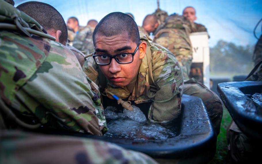 Army armor recruits at Fort Moore, Ga., practice arm immersion cooling June 29, 2023, during their Thunder Run as part of Armor One Station Unit Training. The practice is meant to prevent recruits from overheating on hot days.