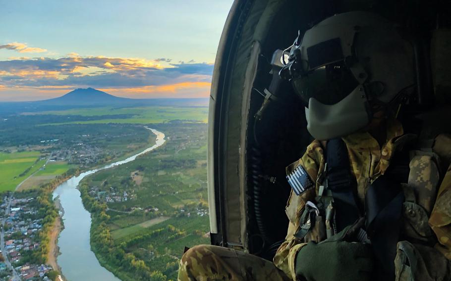  U.S. Army Sgt. Kevin Sanchez, who serves as crew chief with Charlie Company, 3rd General Support Aviation Battalion, 25th Combat Aviation Brigade, studies terrain aboard a UH-60 Blackhawk aircraft as part of a flight survey during Exercise Balikatan 2019 near Mount Pinatubo, Fort Magsaysay, Philippines, April 1, 2019. 