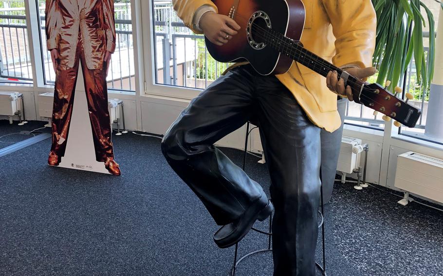 A statue and cutout of Elvis Presley in the tourist office in Bad Nauheim, Germany, Aug. 15, 2021. The spa town hosts the European Elvis Festival in August as a tribute to Presley, who lived in Bad Nauheim from 1958-1960 when he was a U.S. Army private.