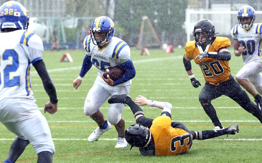 Yokota running back Noah Cruz weaves his way toward the end zone for a third-quarter touchdown during Saturday's rain-drenched Kanto Plain football game at American School In Japan. The Mustangs led 14-6 with 9:42 left when the game was called due to lightning and rescheduled for Oct. 28 at Yokota.