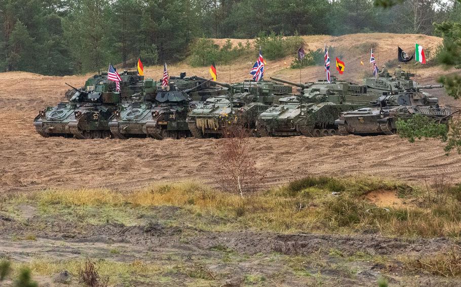 Troops from Germany, Italy, the Netherlands, the U.K. and the U.S., assigned to NATOs enhanced Forward Presence Battle Group Poland, stage their vehicles before a firepower demonstration in Adazi, Latvia, Nov. 13, 2023.