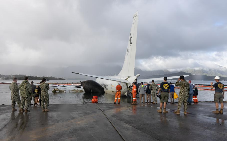 Private industry diving and salvage experts working alongside U.S. Navy sailors  use inflatable salvage roller bags to position the U.S. Navy P-8A Poseidon for extraction from waters just off the runway at Marine Corps Air Station Kaneohe Bay, Marine Corps Base Hawaii, Dec. 2, 2023. 