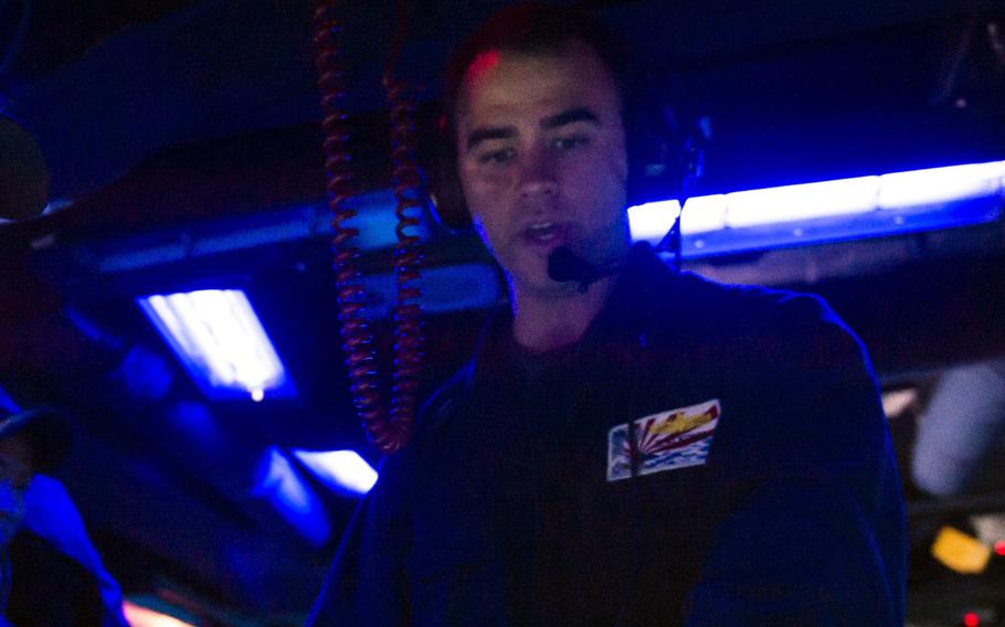 Ridge Alkonis, then a junior-grade lieutenant, works aboard the guided-missile destroyer USS Fitzgerald in the Timor Sea, July 9, 2015.